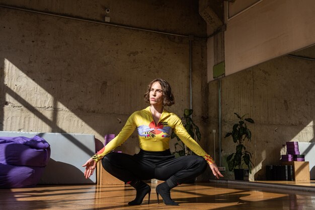 A girl dances a contemporary dance in a sunlit studio