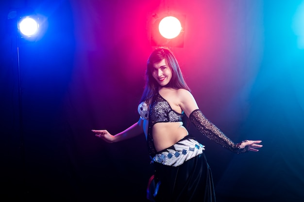 Girl dancing belly dance, fusion or tribal. A woman in a beautiful costume demonstrates charming and