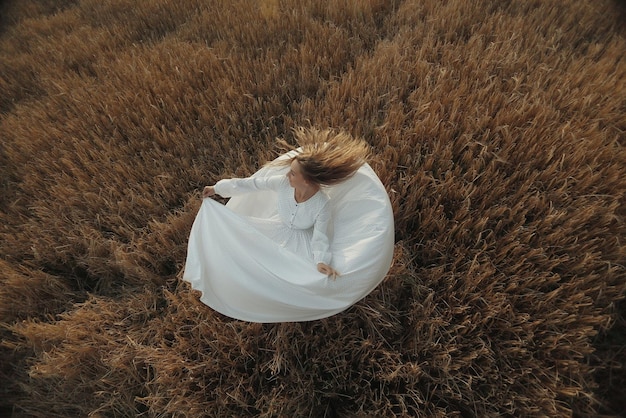 girl dancing in a field in white dress