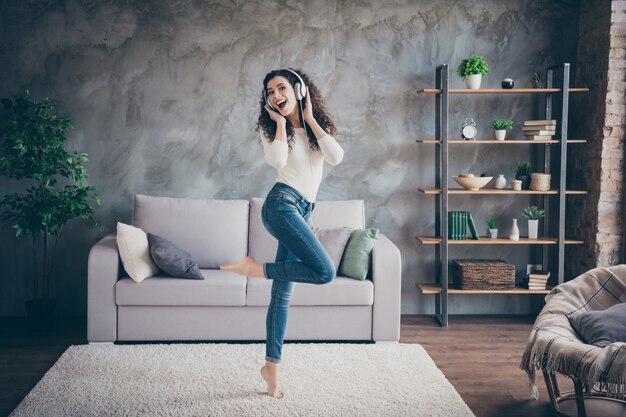 Photo girl dancing listening music modern loft industrial style interior living-room