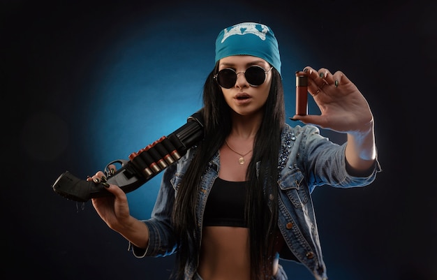 The girl in a denim jacket with a shotgun