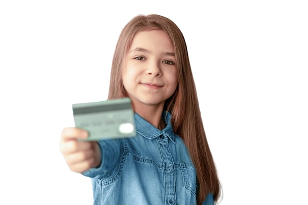 A girl in a denim shirt holds a credit card in her hands isolated on a white background