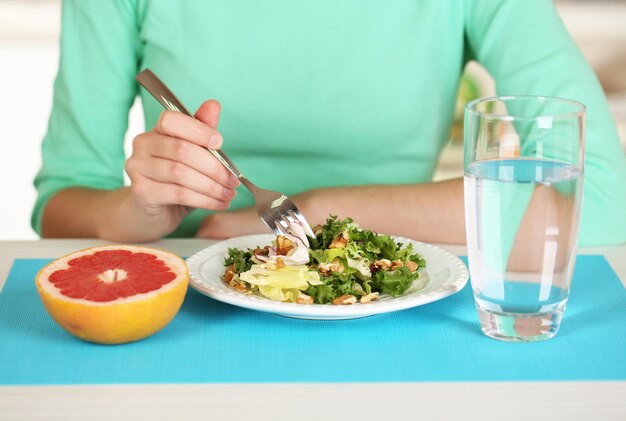 Girl and dietary food at table closeup