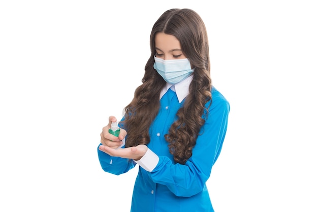 Girl doctor epidemiologist wearing respirator mask during coronavirus pandemic outbreak isolated on white cleaning hands with alcohol-based hand-washing spray, covid 19 disinfectant.