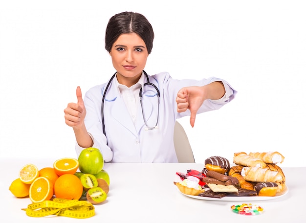 Girl doctor is choice between healthy and unhealthy foods.