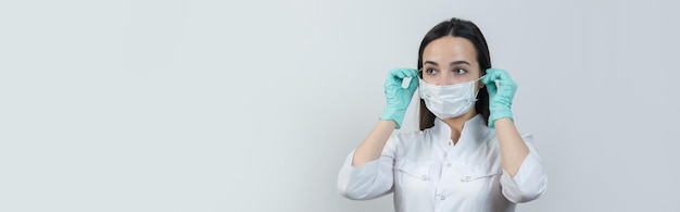 A girl doctor in latex gloves and a white coat is preparing for the procedures.