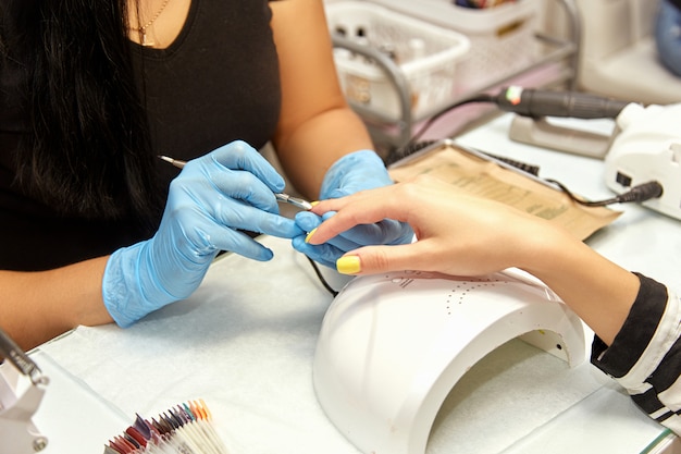 Girl does manicure in the salon