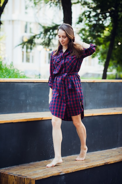 Girl does pirouette walking on a tiptoes against summer park.