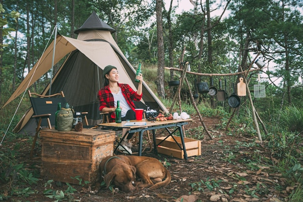 Girl and dog camping in the forest