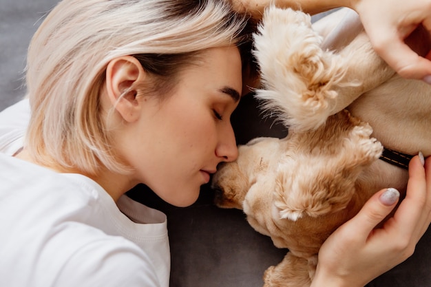 girl and a dog sleep together on a bed