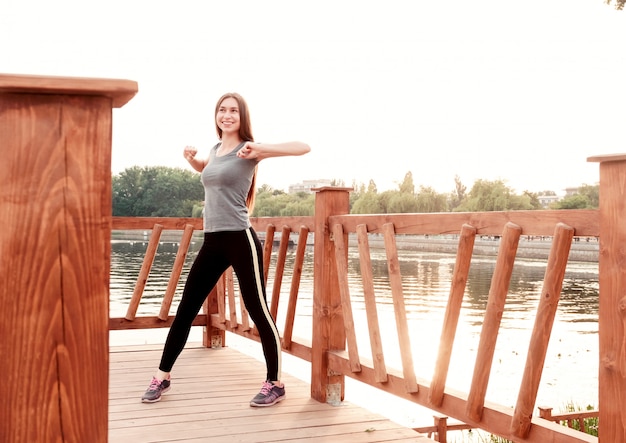 Girl doing exercises on beach early in morning.. Concept of sport, healthy lifestyle, body care.