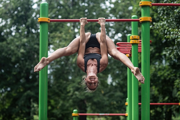 Girl doing exercises on the horizontal bar.