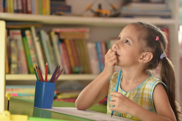 Girl drawing at home