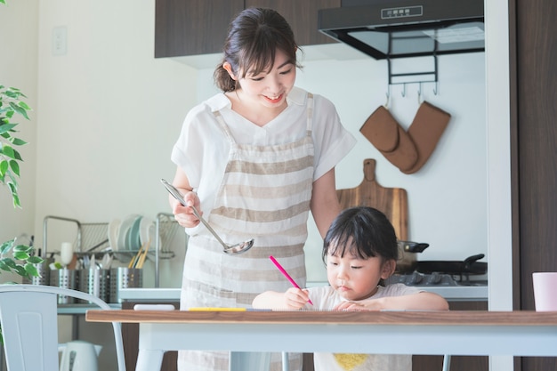 A girl drawing in the kitchen