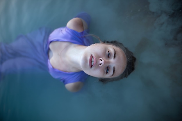 girl in  dress bathes in the lake