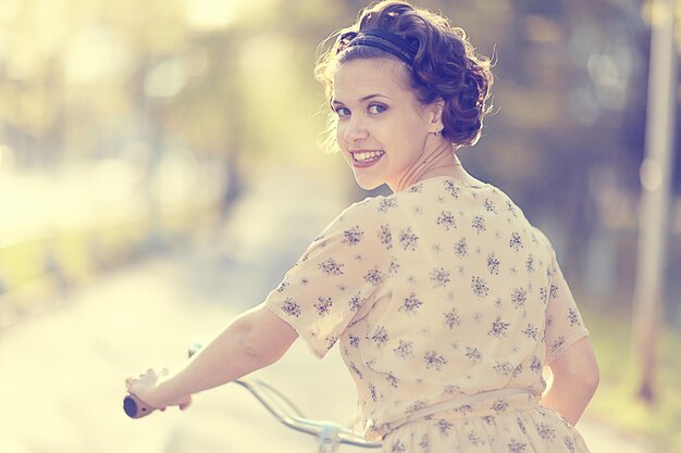 girl in a dress on a bicycle