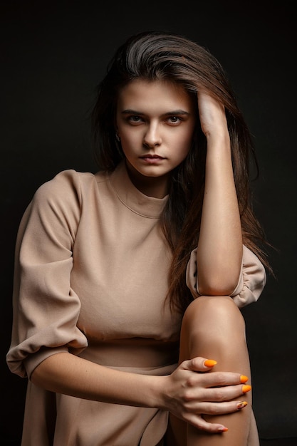 a girl in a dress on a brown background