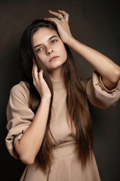 a girl in a dress on a brown background