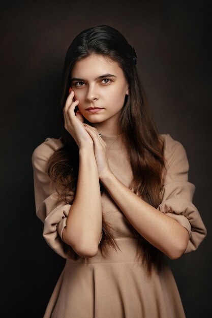 a girl in a dress on a brown background