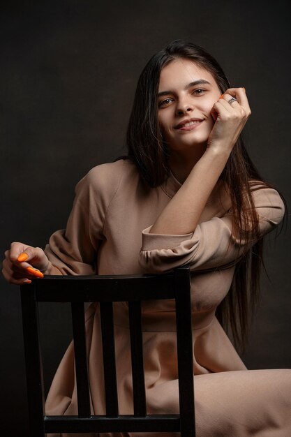 a girl in a dress on a brown background