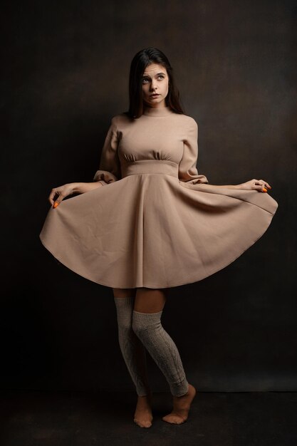 a girl in a dress on a brown background