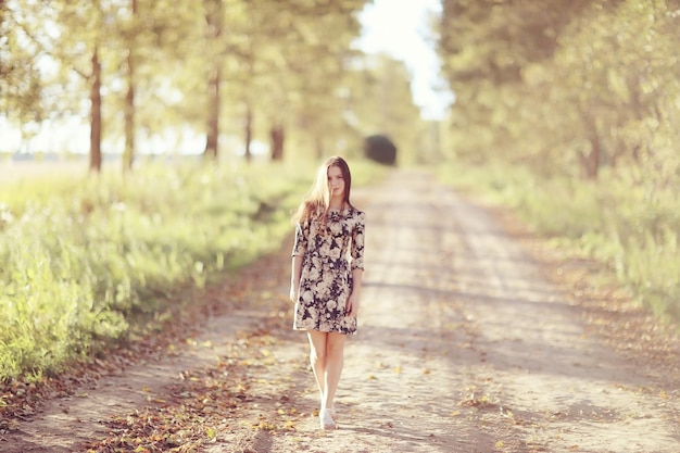 Girl in dress on the summer road