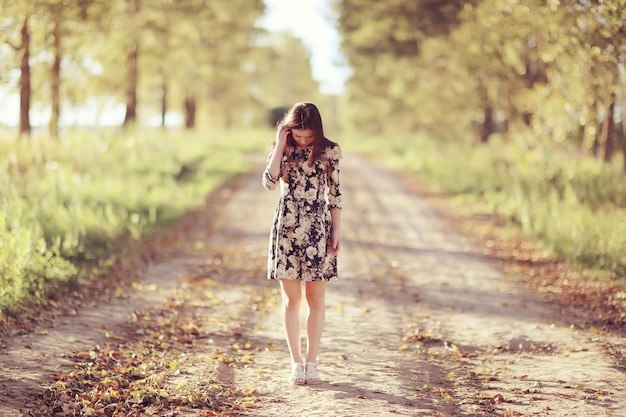 Girl in dress on the summer road