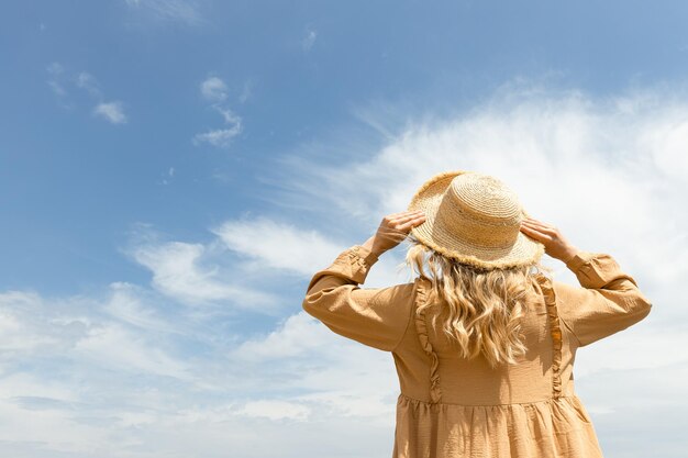 A girl in a dress walks on the beach in the summer