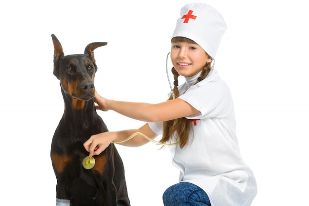 Girl dressed as doctor treating dog