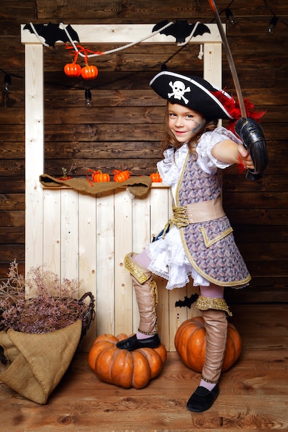 A girl dressed as a pirate with Halloween decorations