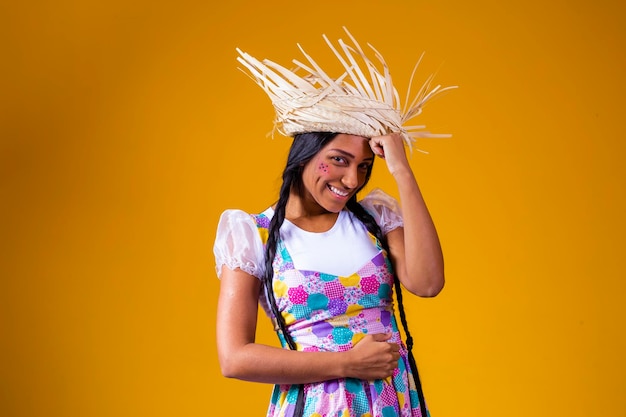 Girl dressed in typical clothes for the Brazilian June party dancing