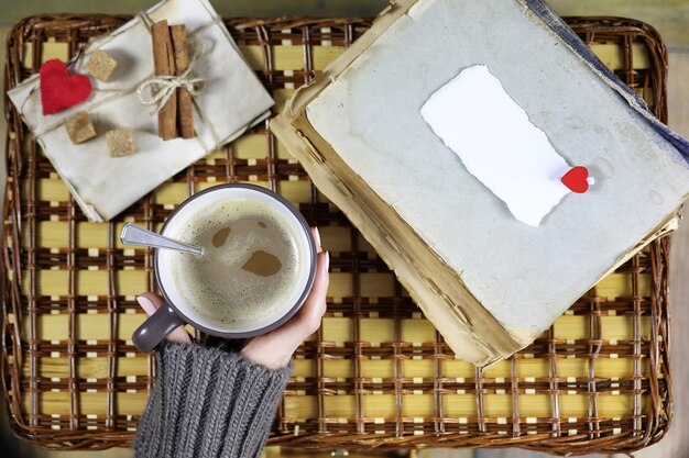 Girl drinking coffee and looking at the card Valentine's Day