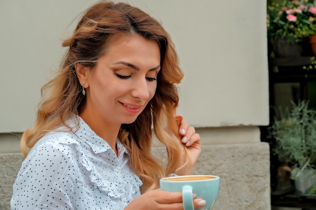 Girl drinking coffee on the street Street Cafe beautiful girl and coffee