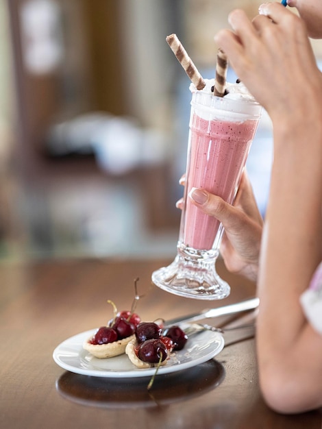 A girl drinking a delicious milkshake