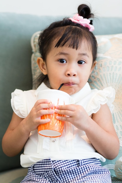 Girl drinking on sofa