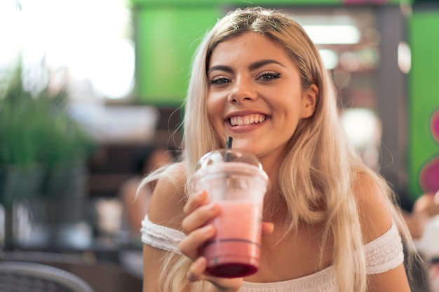 Girl drinking a strawberry smoothie