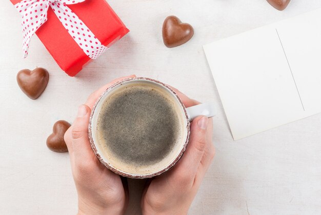 Girl drinks coffee on Valentine's day