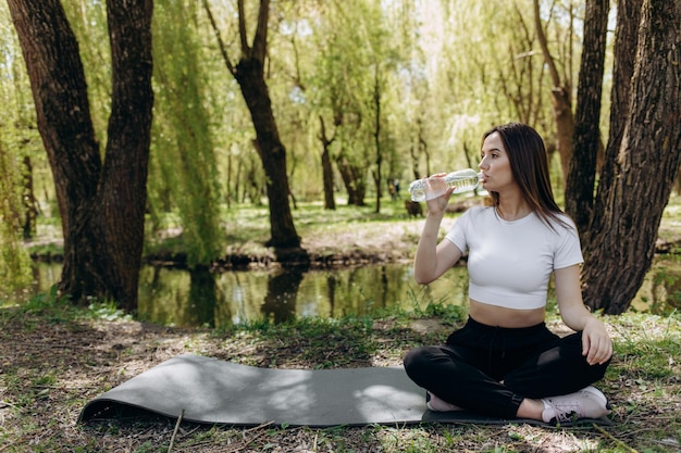 A girl drinks water after sport