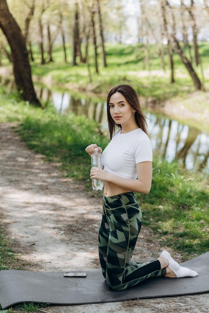 A girl drinks water after sport