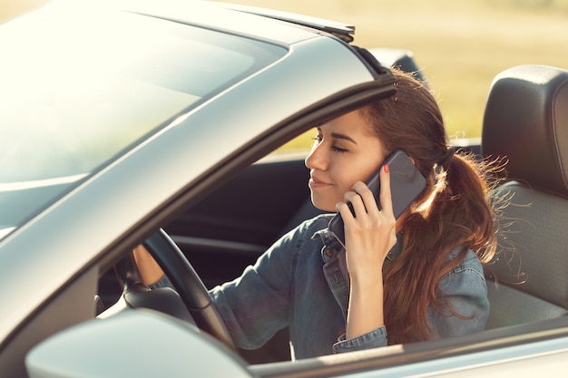 Girl driver with mobile phone