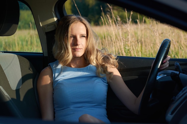 A girl driving a carview through glass