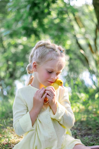 A girl and a duckling in the summer outdoors Gute babies Happiness