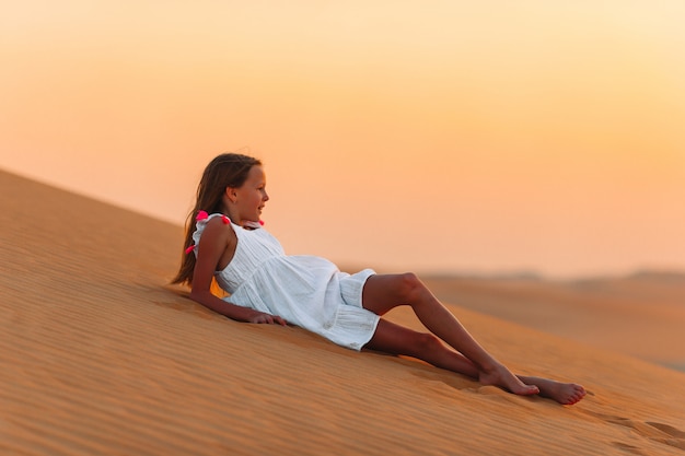 Girl among dunes in Rub al-Khali desert in United Arab Emirates