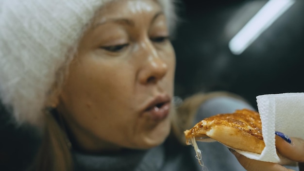 Girl eat pizza cheese four Close up of young woman mouth greedily eating pizza and chewing