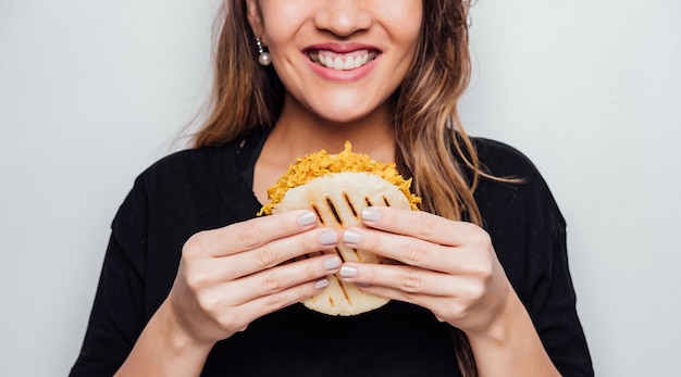 Girl eating arepa