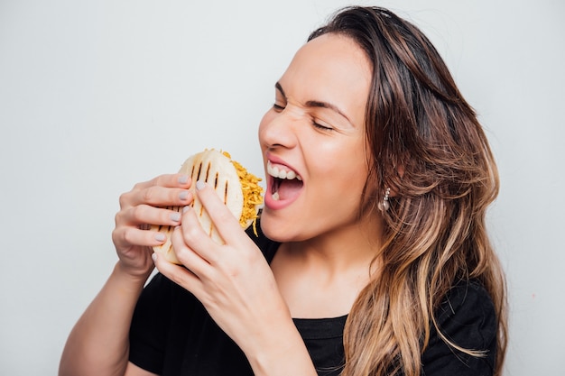 Girl eating arepa