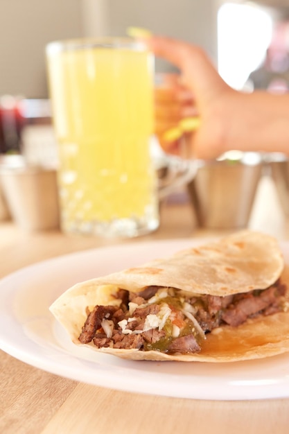 Girl eating delicious taco with salsa and a variety of\
toppings