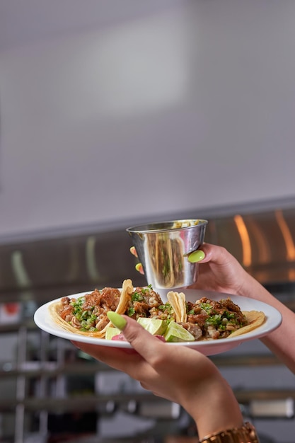 Girl eating delicious taco with salsa and a variety of
toppings