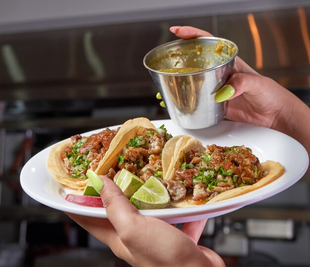 Girl eating delicious taco with salsa and a variety of\
toppings