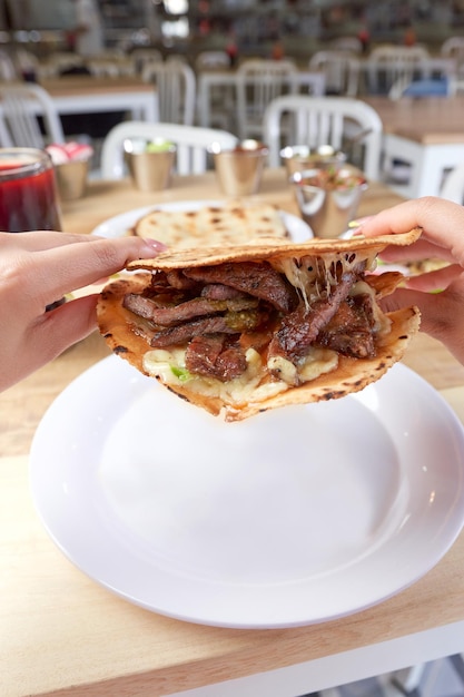 おいしい典型的なメキシコ料理のタコスを食べる女の子 sopes 牧師など